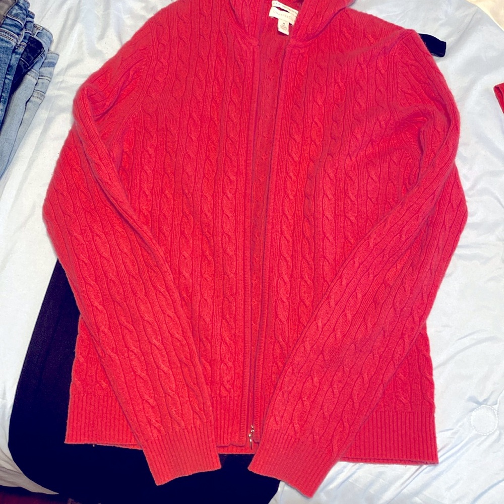 Cashmere pink sweater with full zipper front and long sleeves. 100% cashmere.